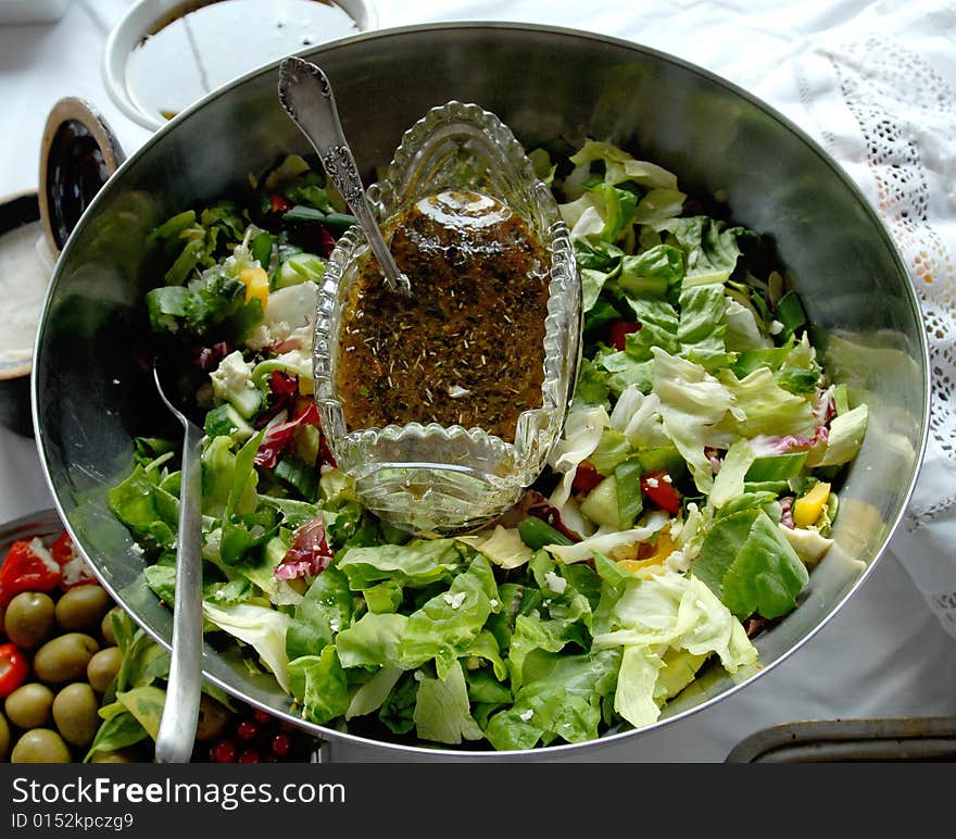 Lettuce with the sauce spoon-feeded and the sauce boat. Lettuce with the sauce spoon-feeded and the sauce boat.