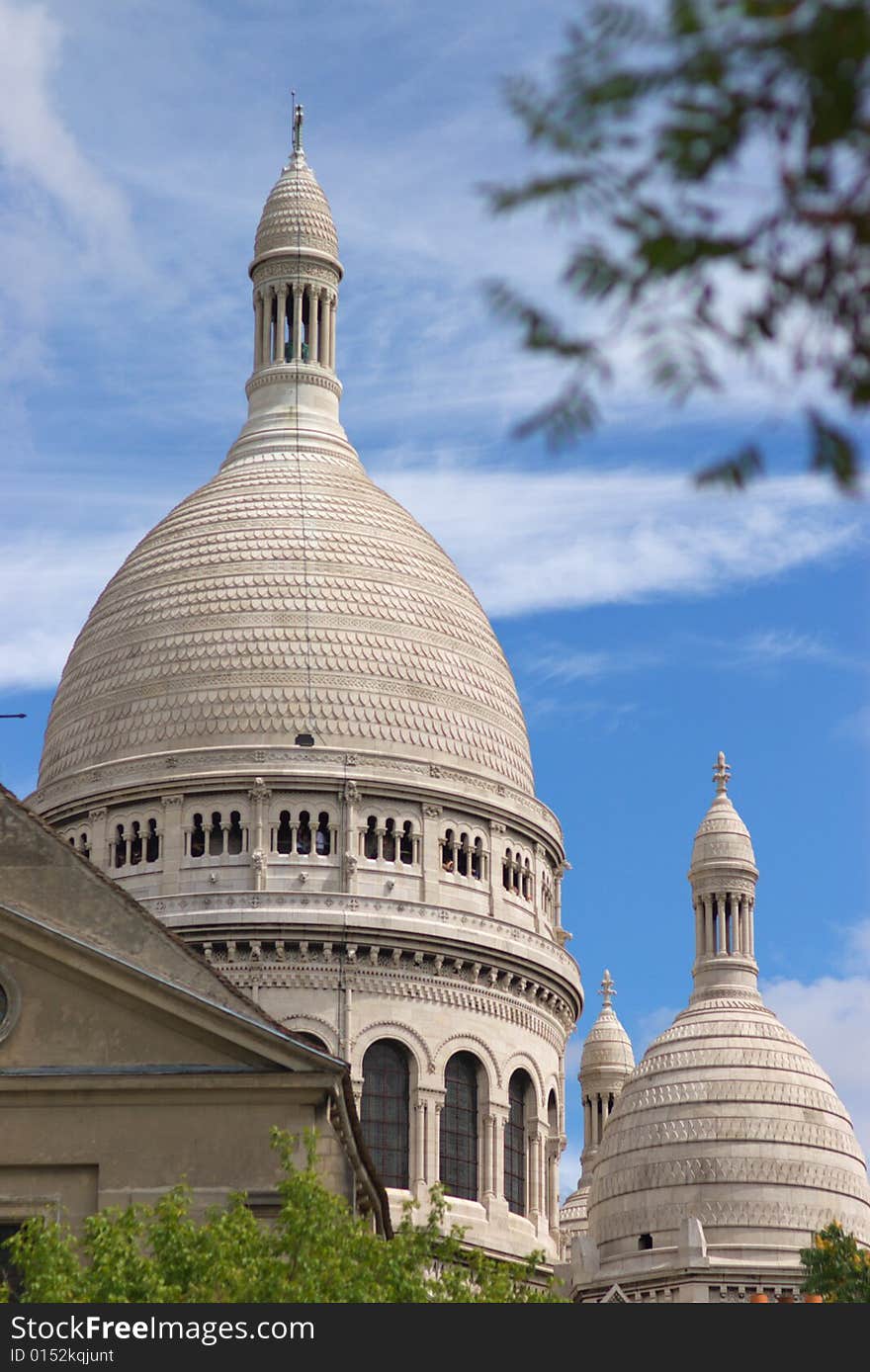 Cupolas of basilica Sacré-Coeur of Paris, vertical, Blue sky and trees,