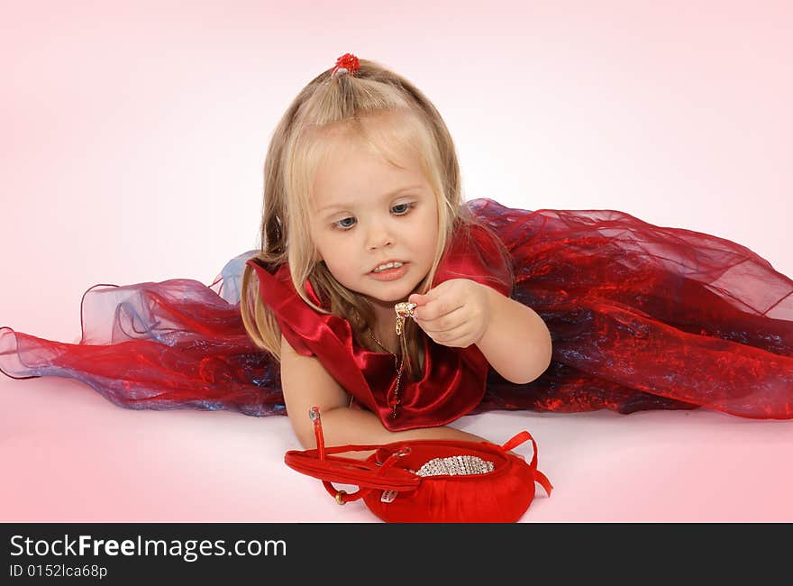 Portrait of the beautiful girl in a red dress