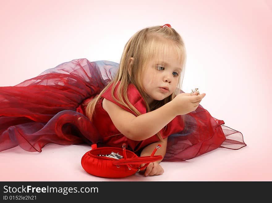 Portrait of the beautiful girl in a red dress