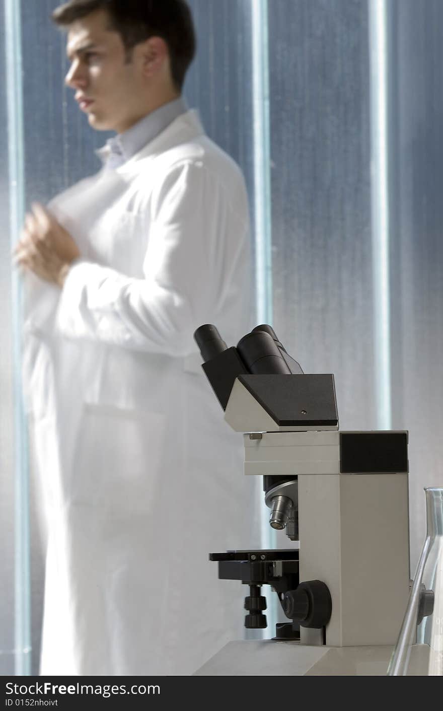 Scientist thinking in his lab near the microscope. Scientist thinking in his lab near the microscope