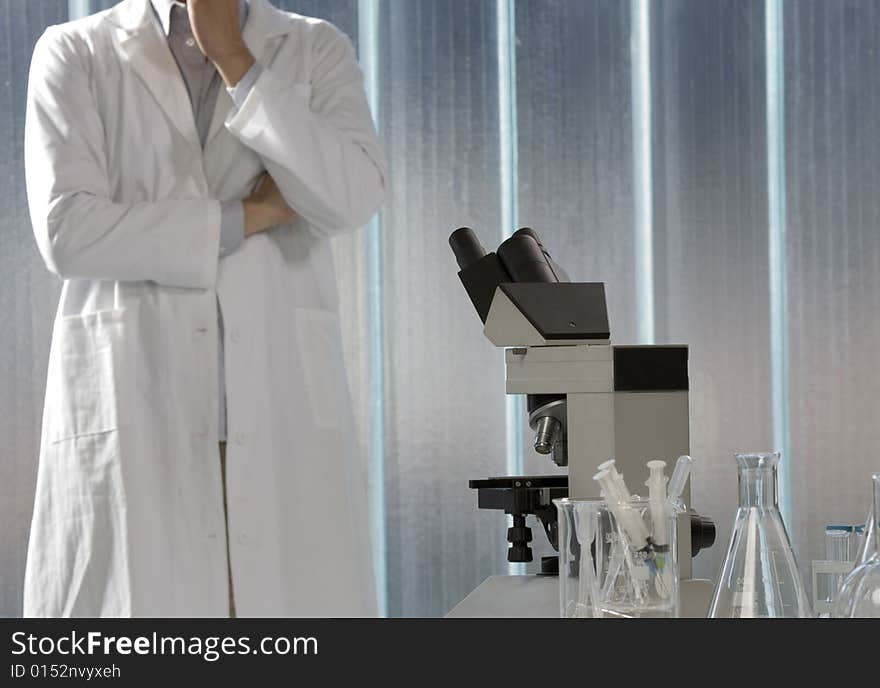 Scientist thinking in his lab, focus on the microscope. Scientist thinking in his lab, focus on the microscope