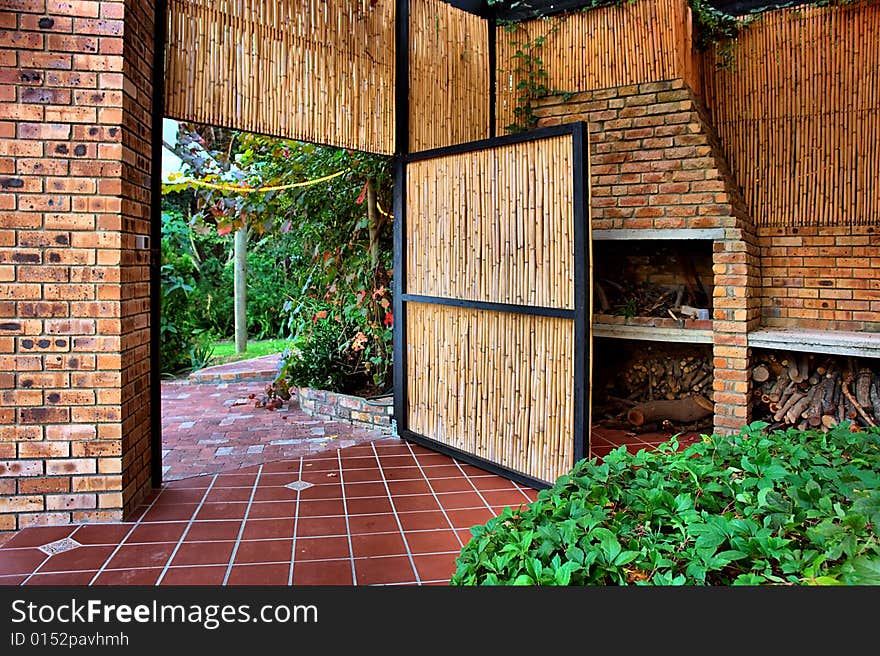 Reed door into garden. Shot in farm near Stellenbosch, Western Cape, South Africa.