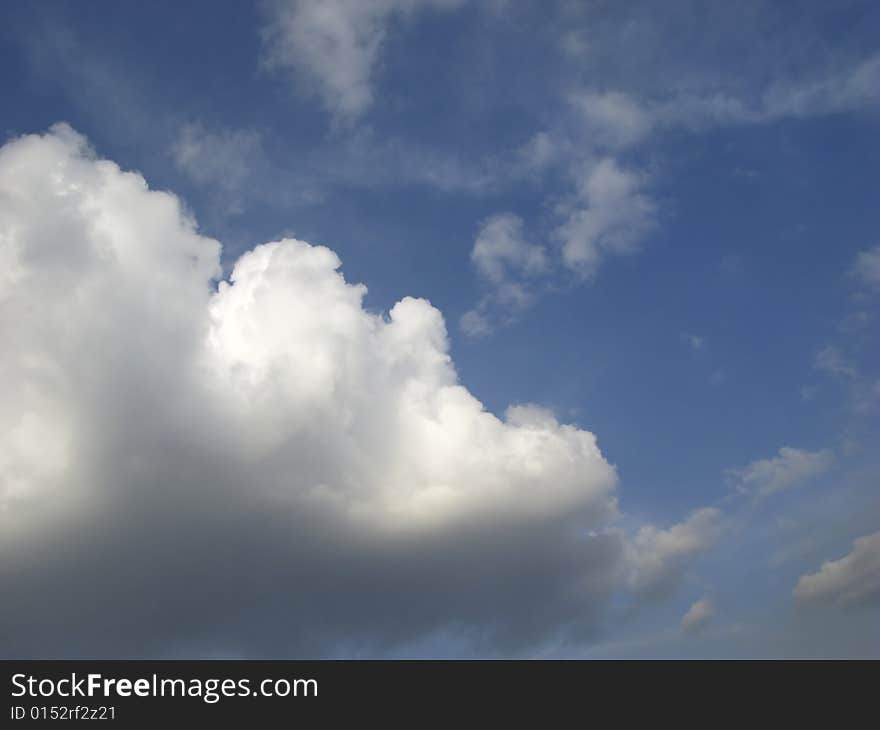 Big white clouds in  dark blue sky