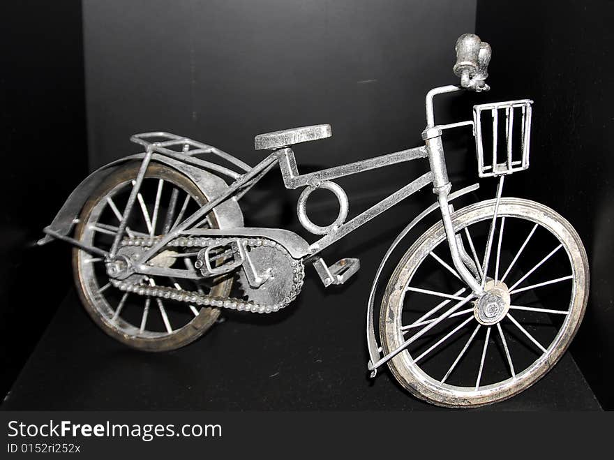 Miniature replica authenticates old bicycle with front basket. Miniature replica authenticates old bicycle with front basket