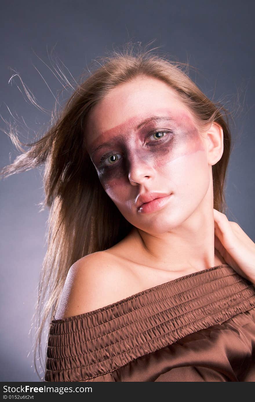 Studio portrait of a young blond woman with aggressive make-up