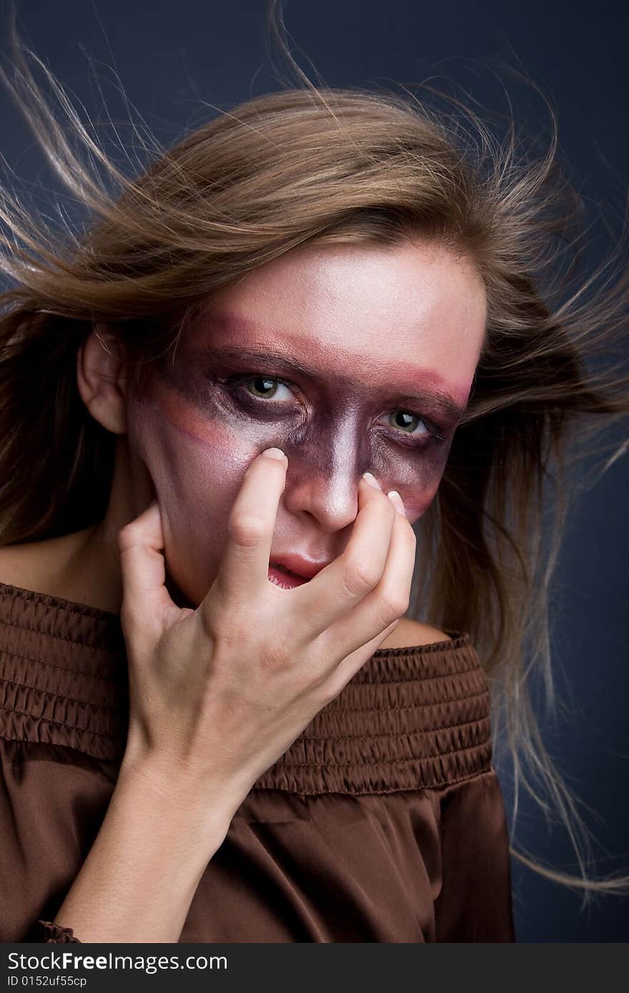 Studio portrait of a young blond woman with aggres