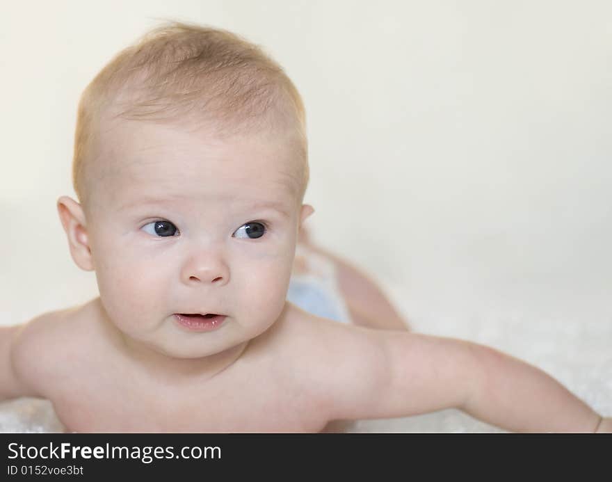 Adorable baby looking with great intent at something off to the side. Adorable baby looking with great intent at something off to the side