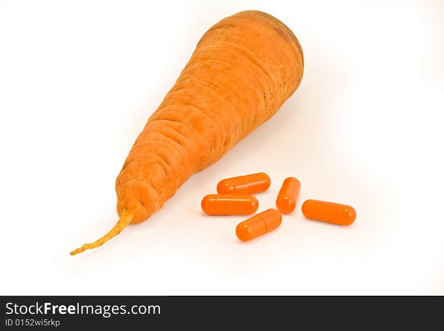 Vitamin pills with carrot on isolated white. Make your choice. Vitamin pills with carrot on isolated white. Make your choice