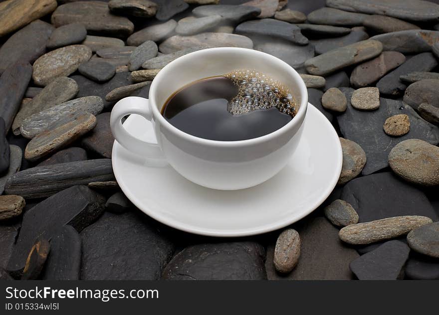 Cup Of Coffee Against Black Stones