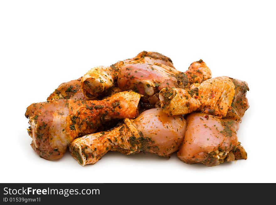 Raw chicken drumsticks on white background