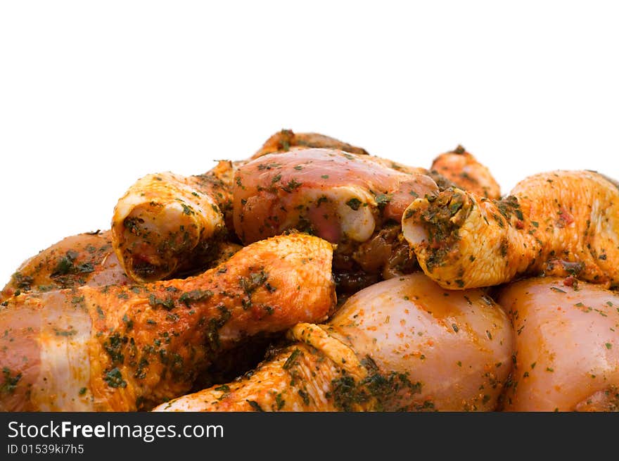 Raw chicken drumsticks on white background