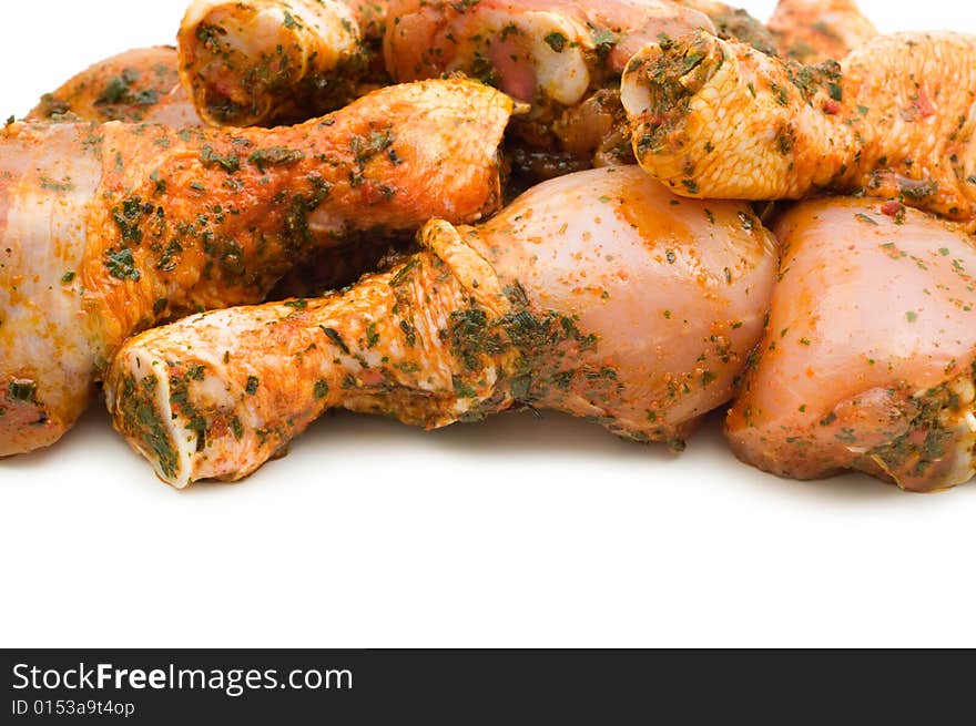 Raw chicken drumsticks on white background