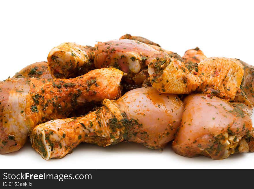 Raw chicken drumsticks on white background