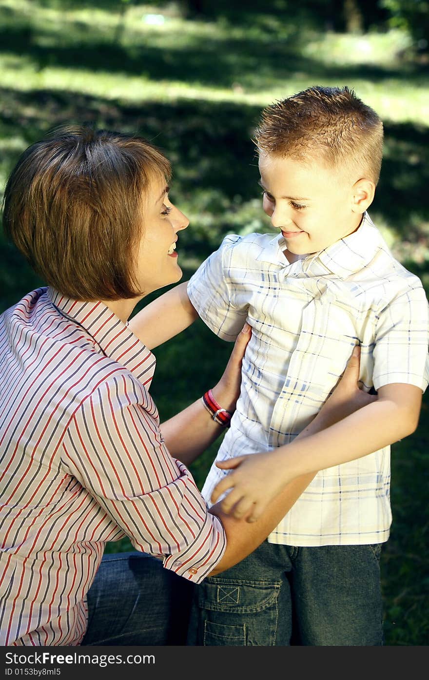 Mother and son looking at each other smiling in the nature. Mother and son looking at each other smiling in the nature