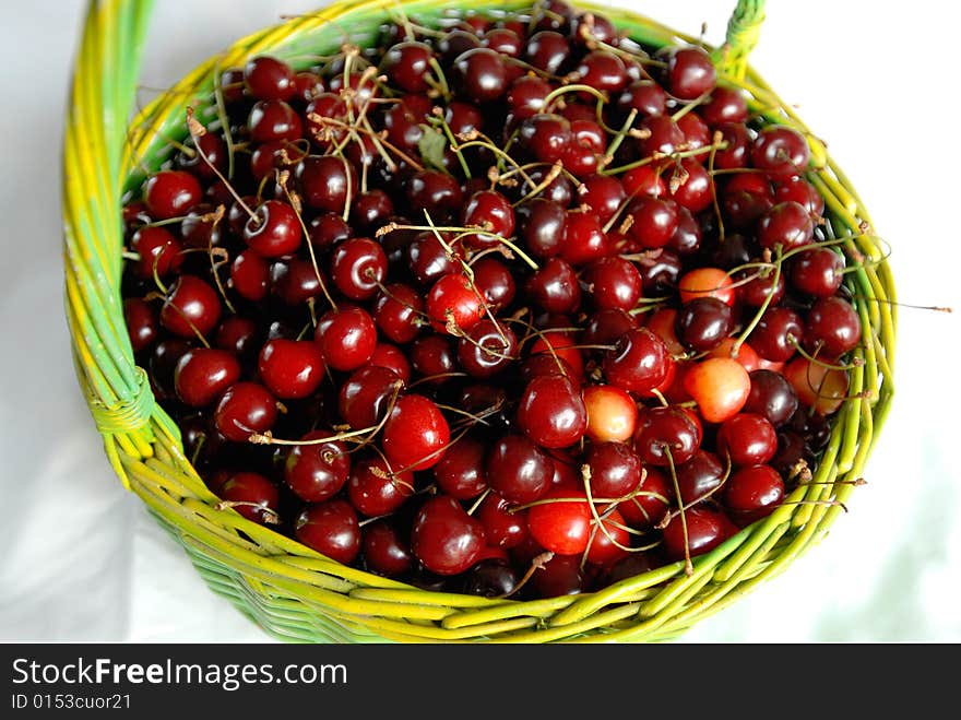 Colourful cherry in round basket. Colourful cherry in round basket