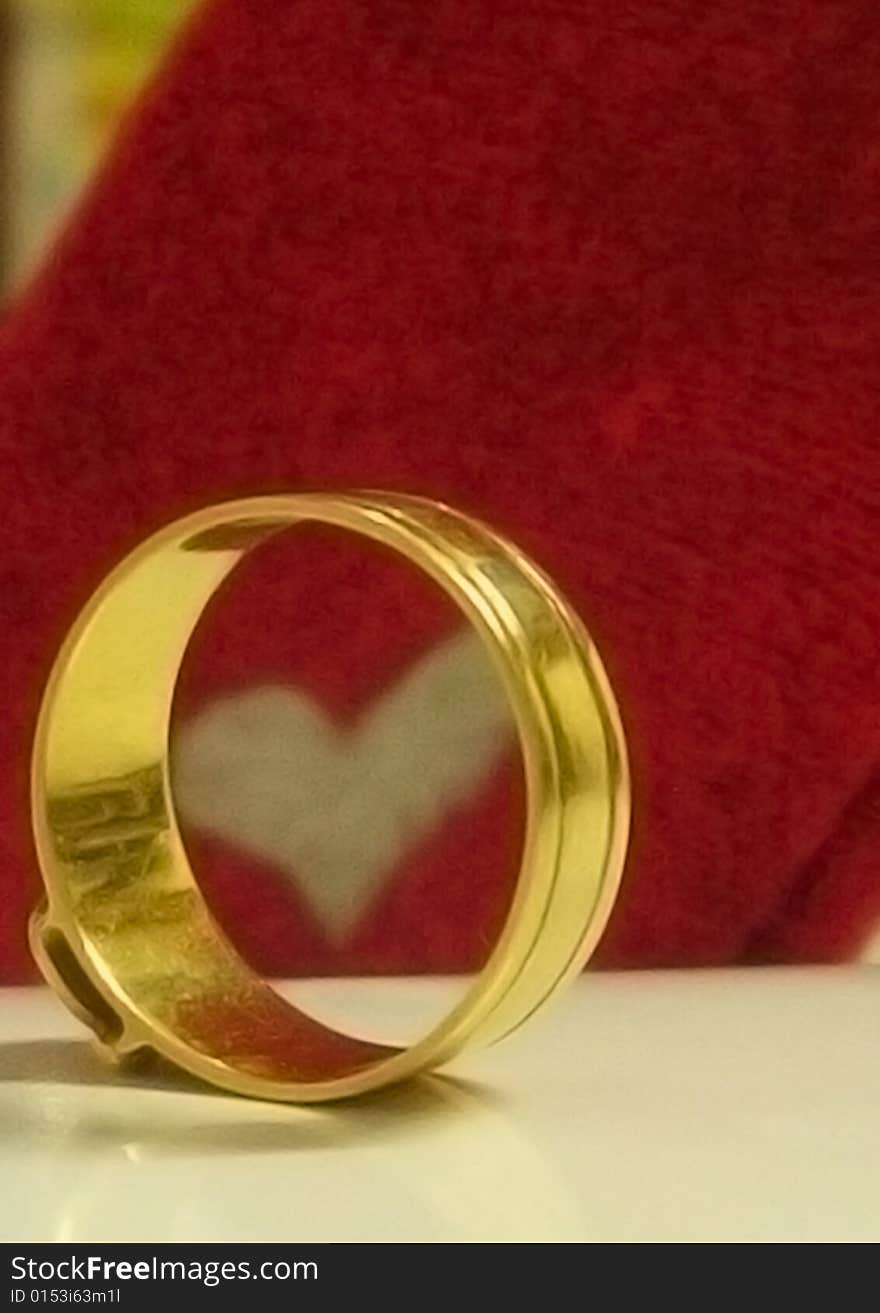 Golden ring and heart is a symbol of love and wedding