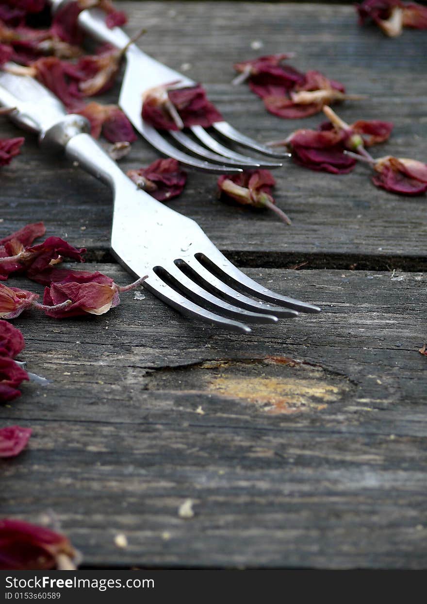 Forks. A tableware. An old wooden table.