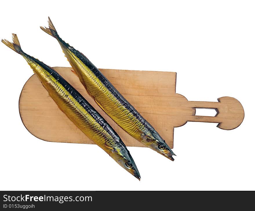 Two smoked fishes (Scombresox Saurus) on wooden board