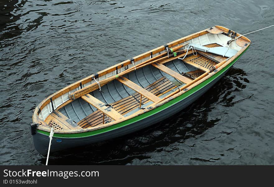 Life-boat attached with ropes on water surface