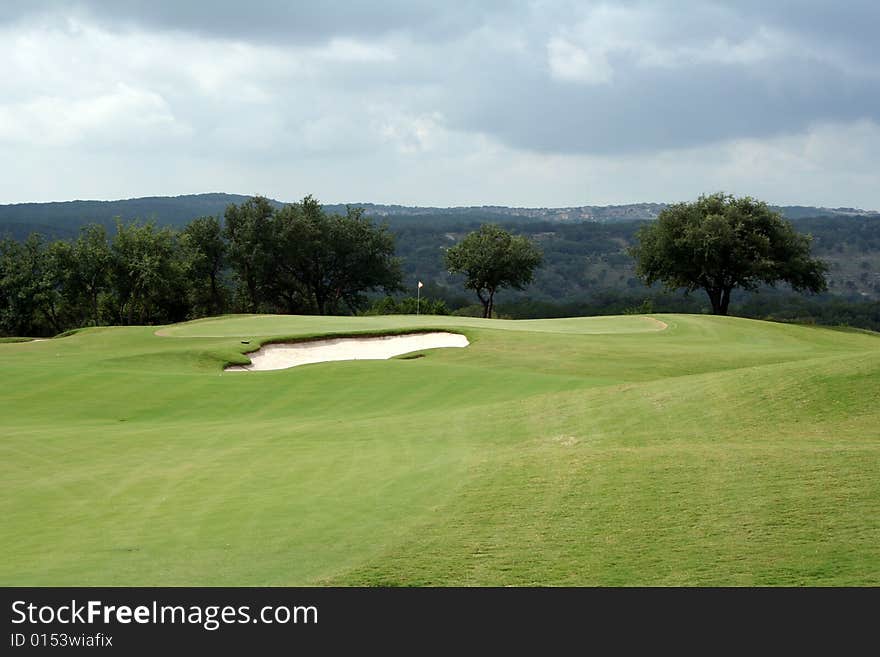 A view of the green on a scenic hill country golf course. A view of the green on a scenic hill country golf course