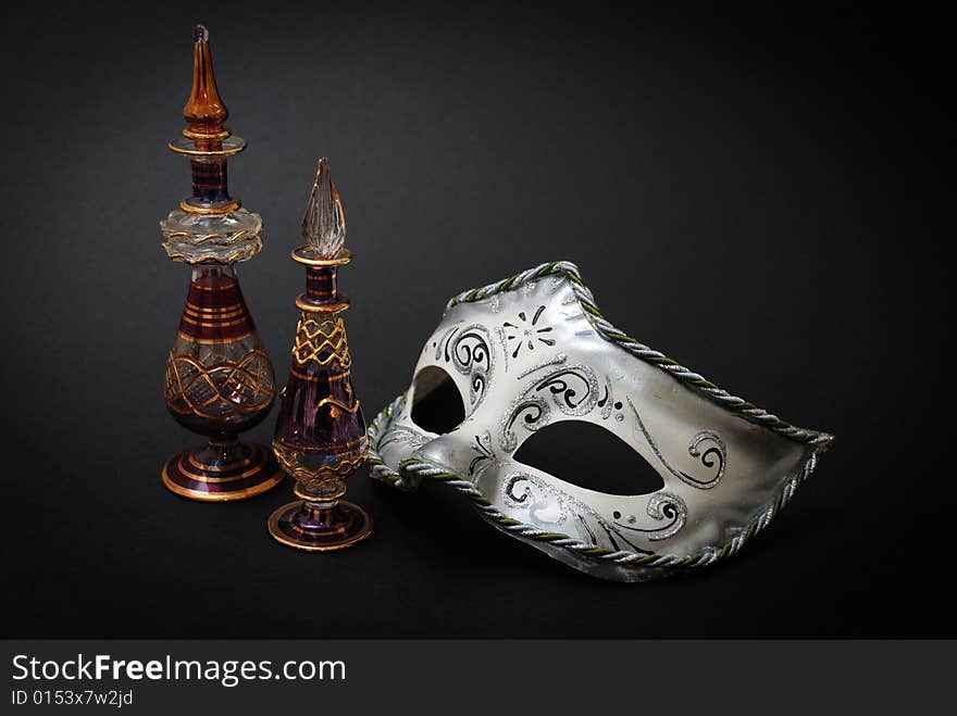 Two Venetian Glass jugs and a Venetian mask on black background. Two Venetian Glass jugs and a Venetian mask on black background