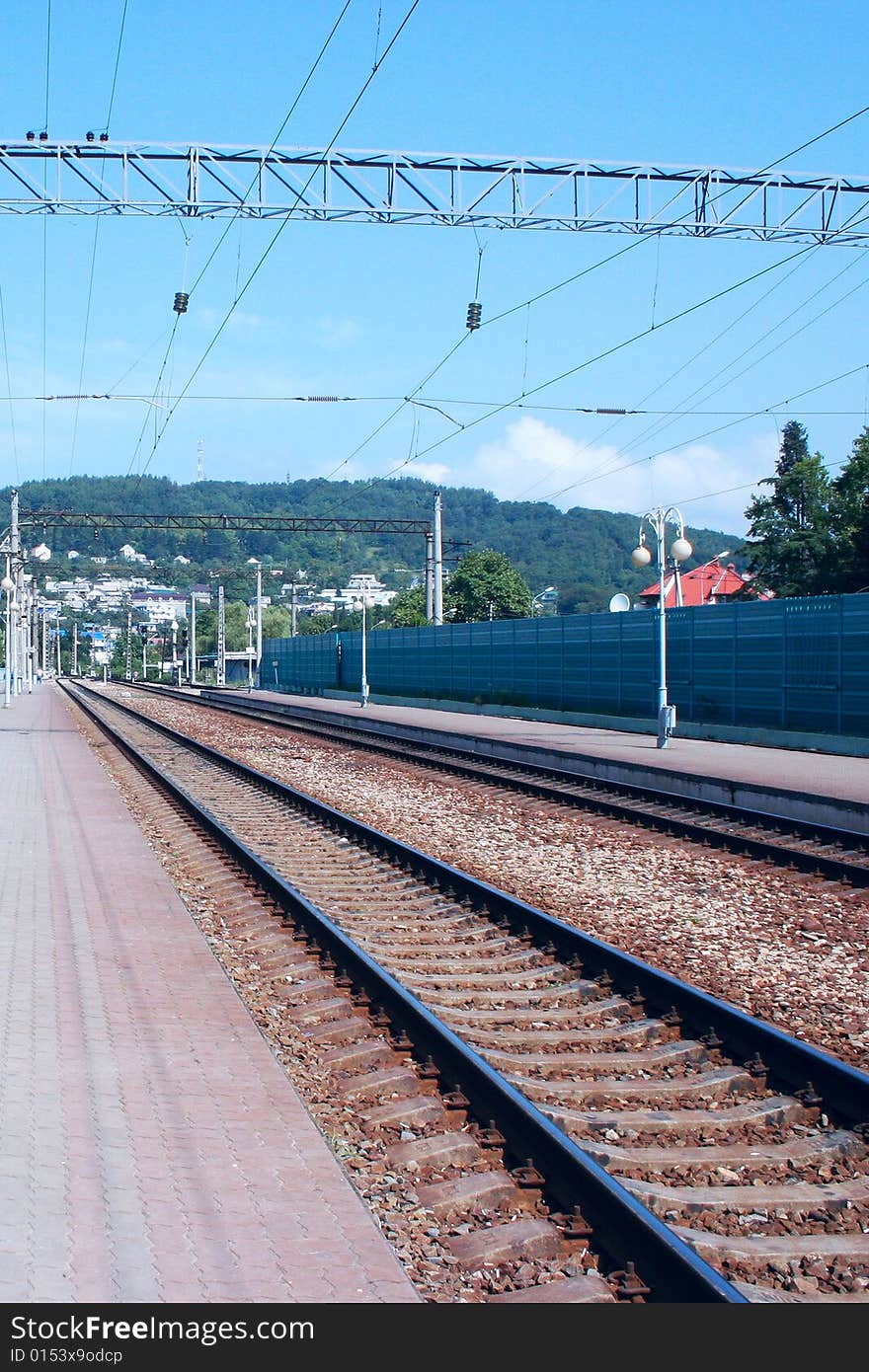 Platform to railway station year daytime on background of the mountains