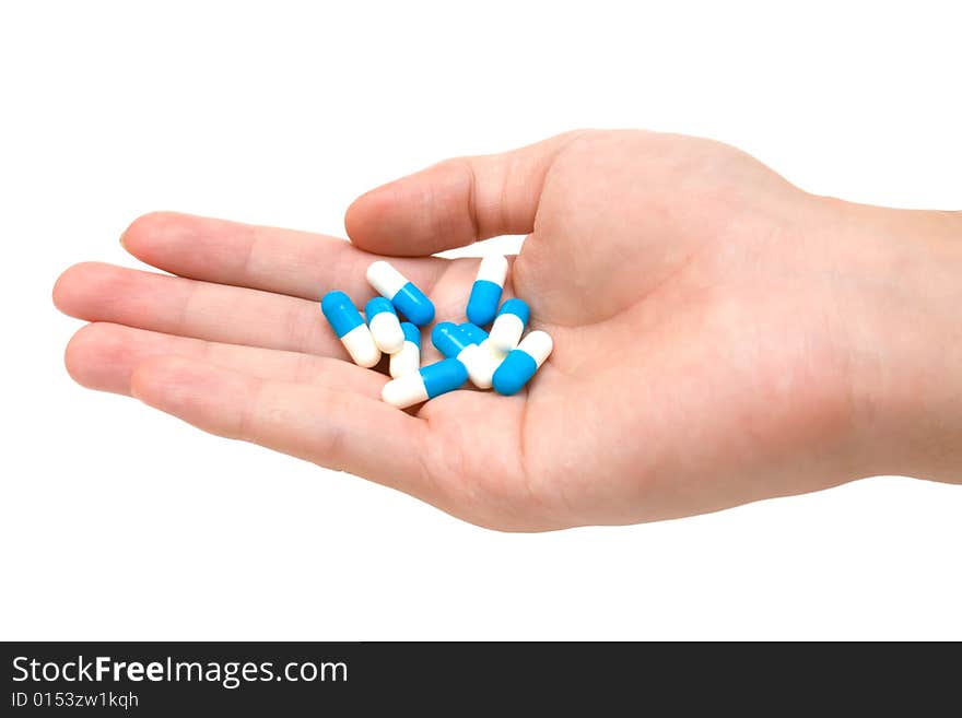 Pills on palm on white background