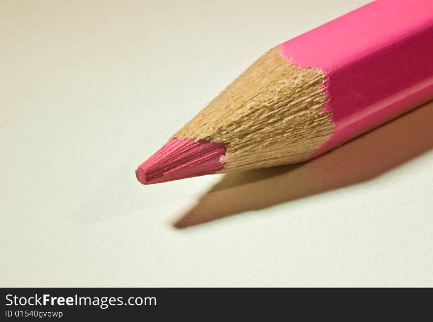 A violet pencil lying diagonal on a table. A violet pencil lying diagonal on a table.