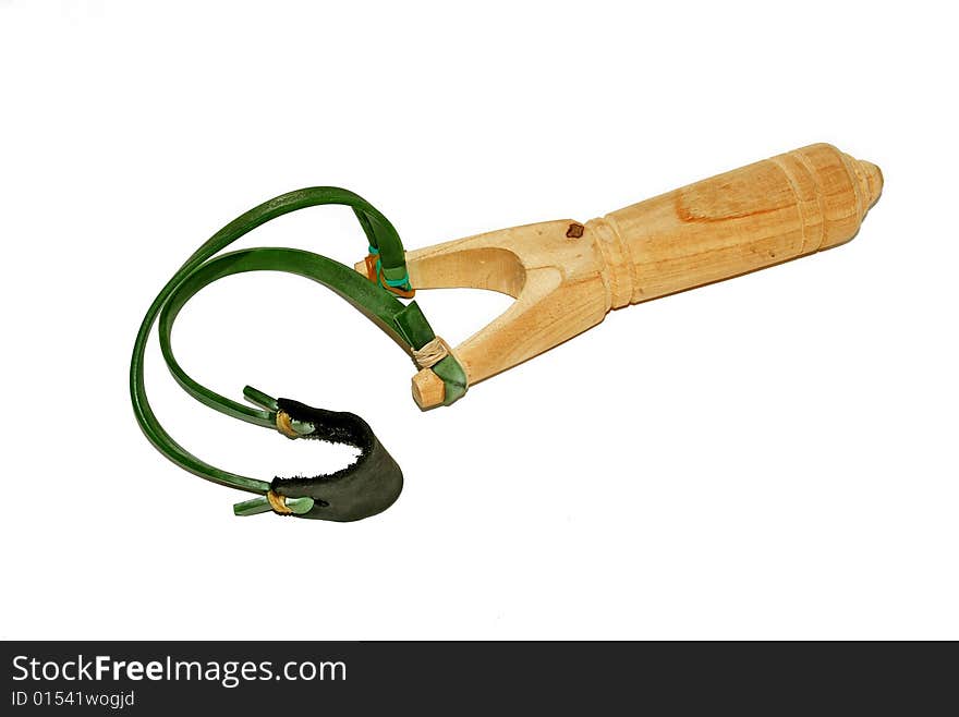 Wooden slingshot with green ribbon isolated over white