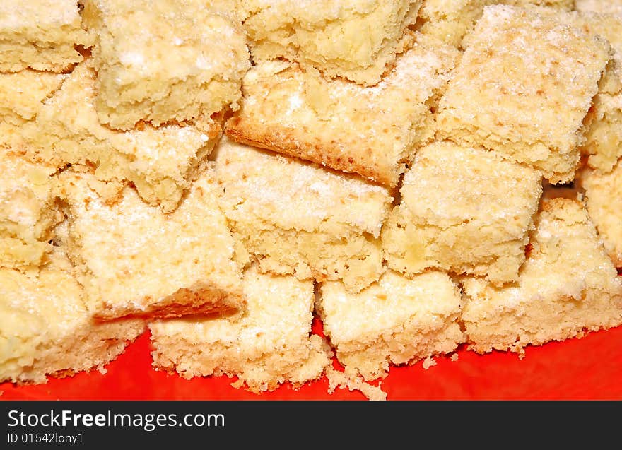 Appetizing pastry pieces on red plate background