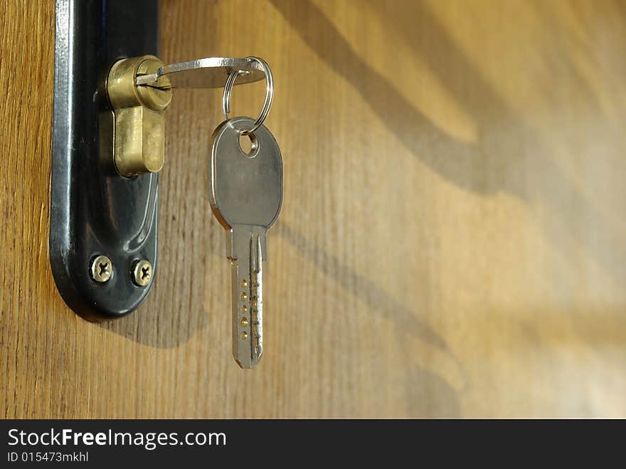 A hotel room door lock and key