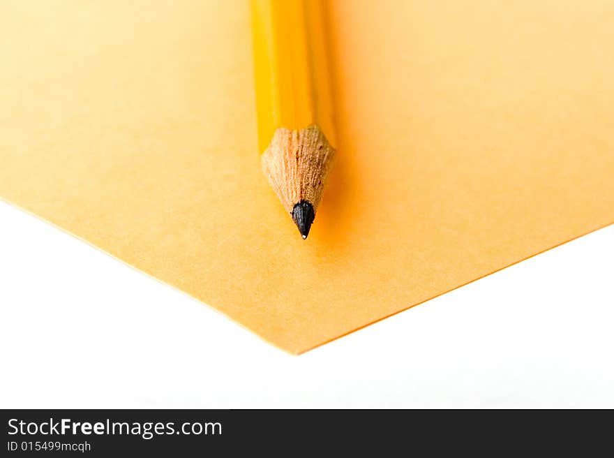 A photo of yellow pencil and yellow sheet of paper