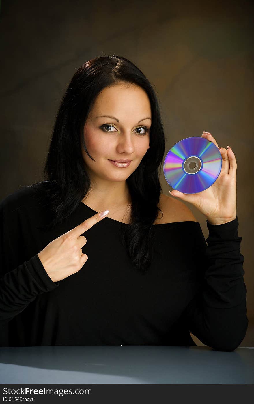 Girl with DVD  disk in the studio