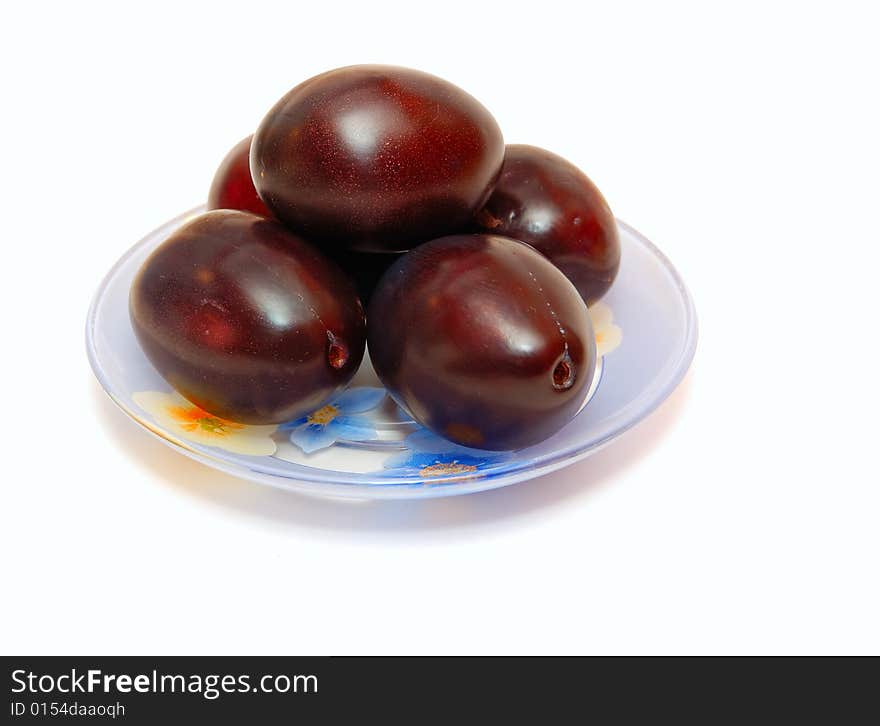 The ripe plums lying on a plate. The ripe plums lying on a plate