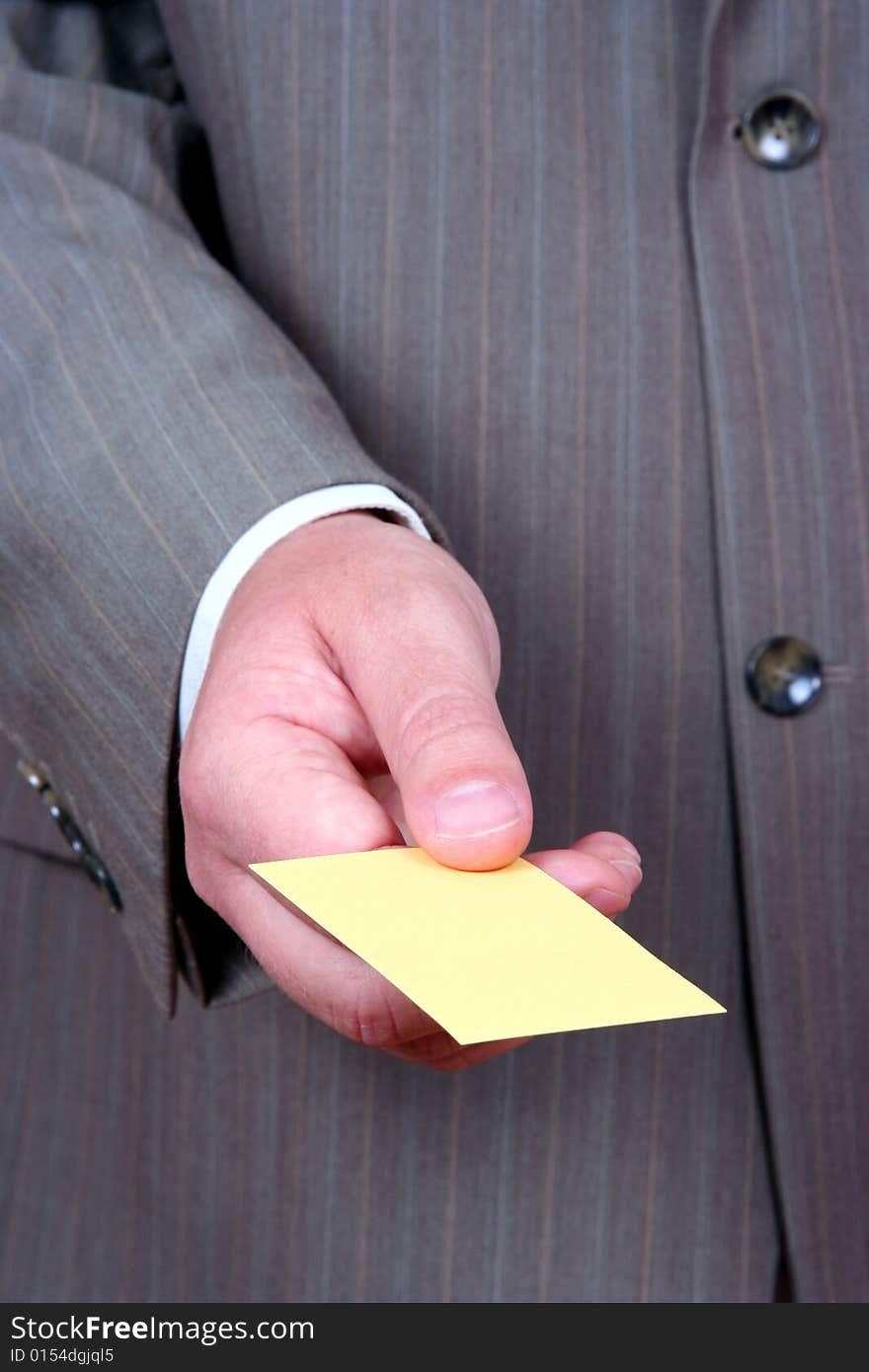 Businessman offering yellow business card. Businessman offering yellow business card