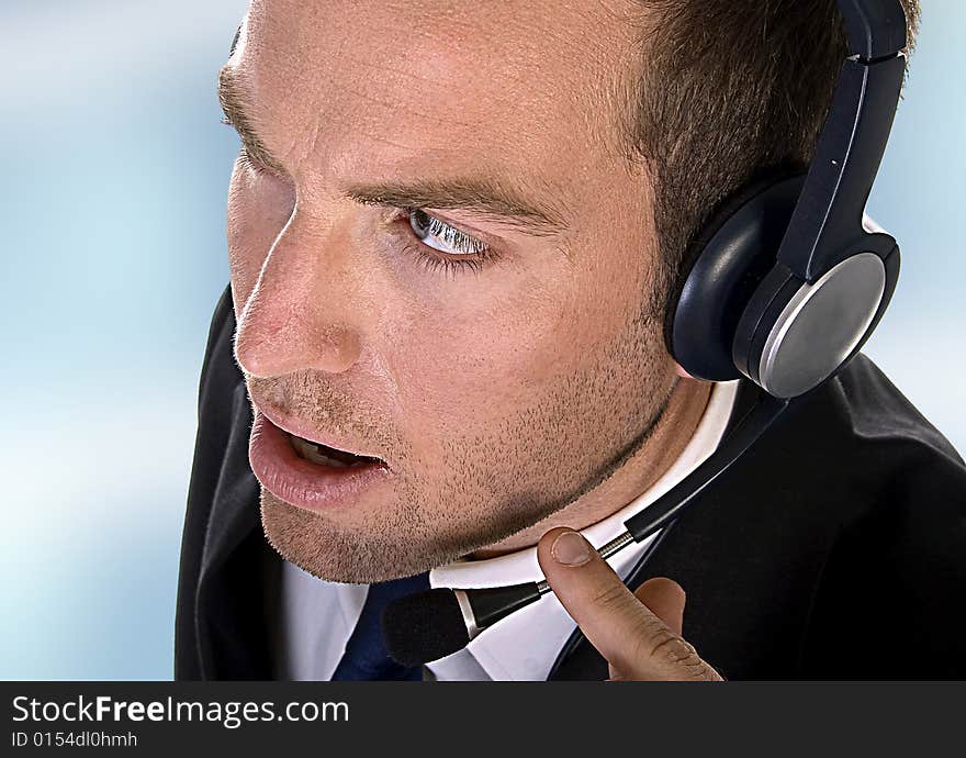 Young businessman with headphones on an abstract background