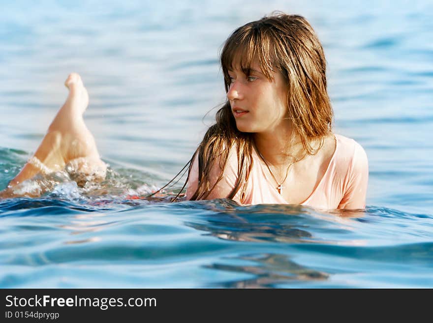 Beautiful girl laying in water. Beautiful girl laying in water