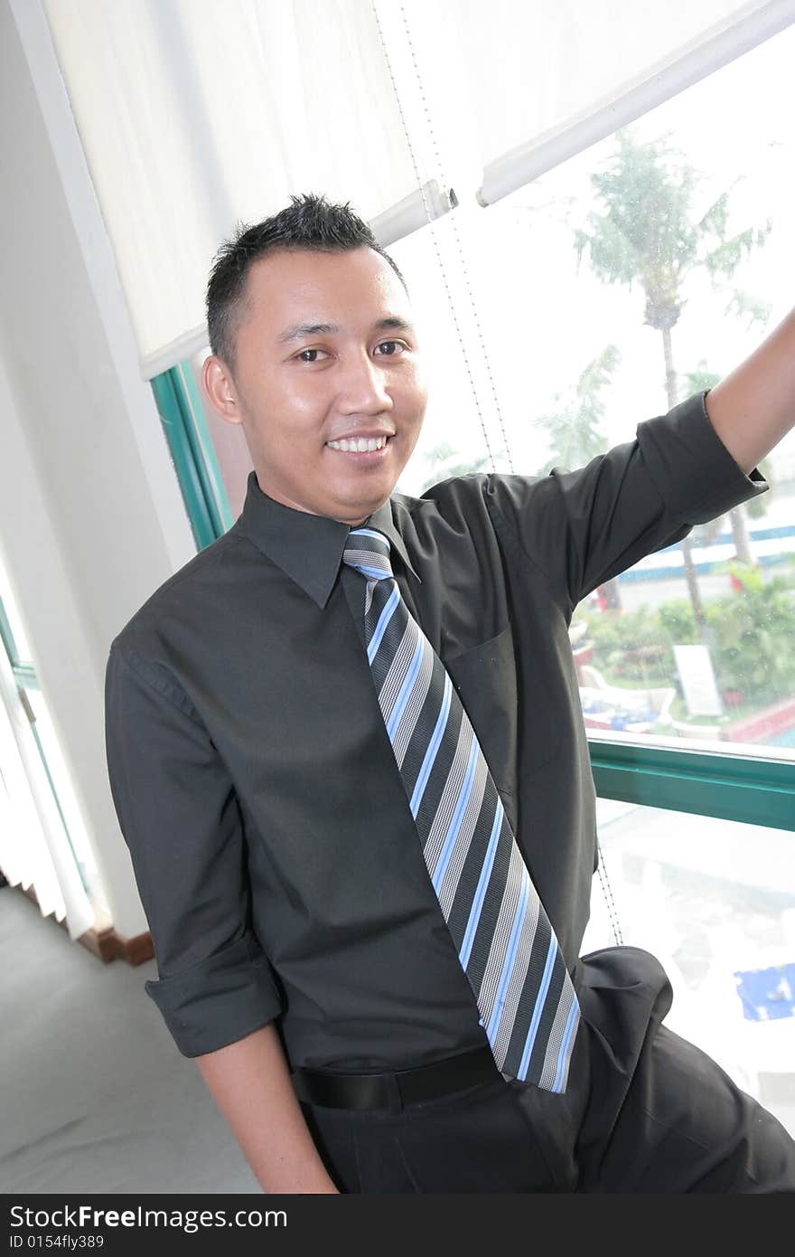 Business man at second floor office window