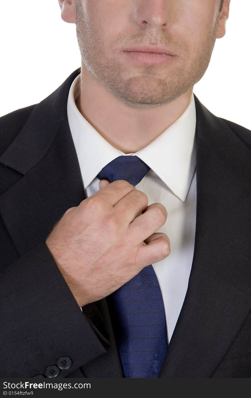 Close up of businessman fixing his tie on an isolated white background