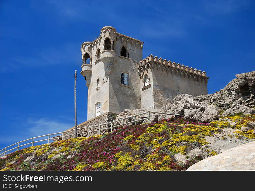 Moresque building on stony hill moss-grown against blue sky, Castle of Guzman el Bueno. Moresque building on stony hill moss-grown against blue sky, Castle of Guzman el Bueno