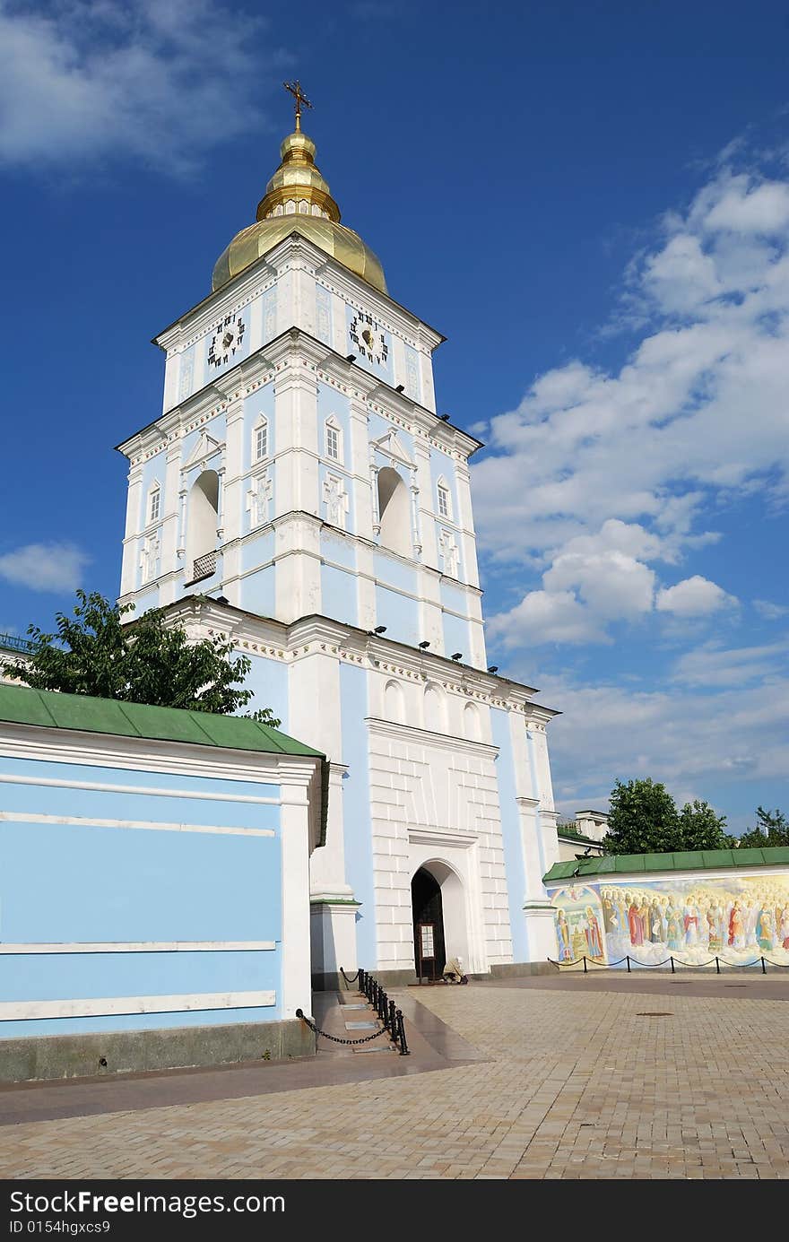 Bell tower above entrance in orthodox cathedral of Saint Michael, golden domes against blue sky. Bell tower above entrance in orthodox cathedral of Saint Michael, golden domes against blue sky