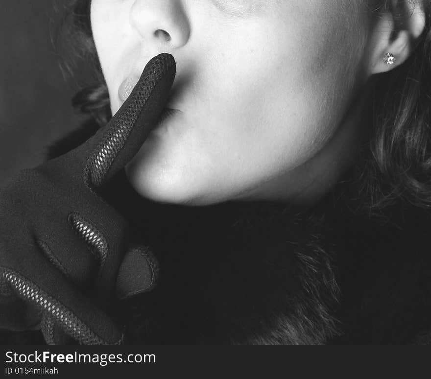 Woman´s face in black and white with hand in front of the mouth. Woman´s face in black and white with hand in front of the mouth