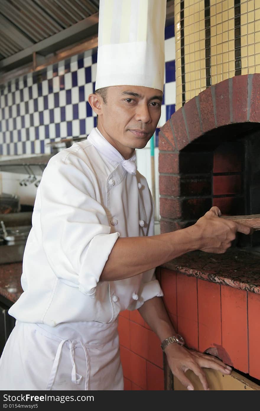 Chef standing at front of pizza restaurant. Chef standing at front of pizza restaurant