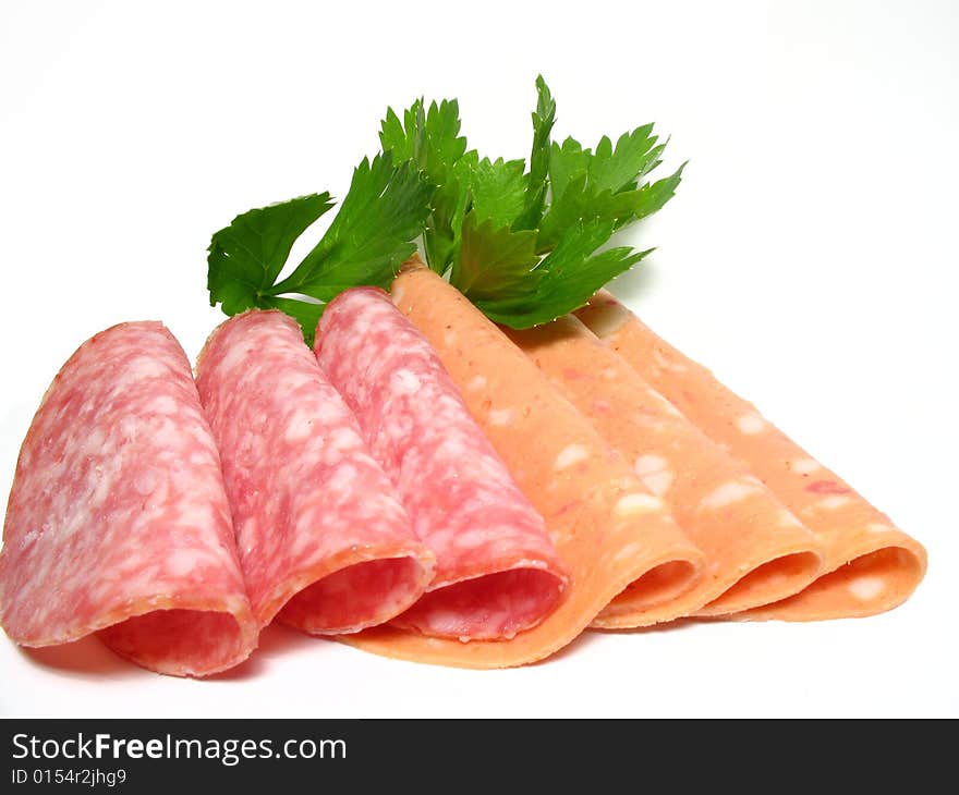 Detail fresh sliced salamis and parsley leaf