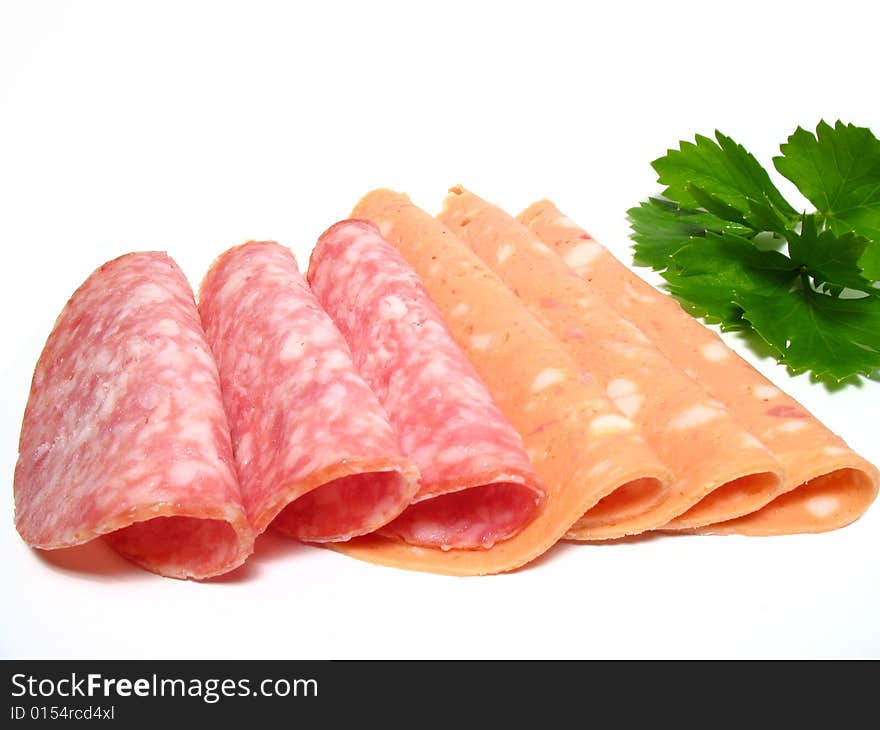 Detail fresh sliced salamis and parsley leaf