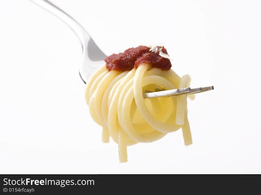 Spaghetti on a fork over white background