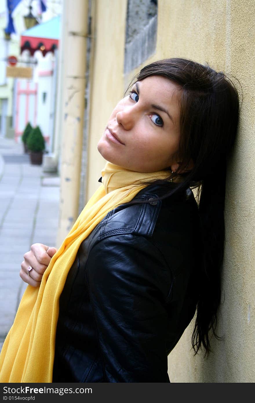 A girl with yellow scarf on the street. A girl with yellow scarf on the street