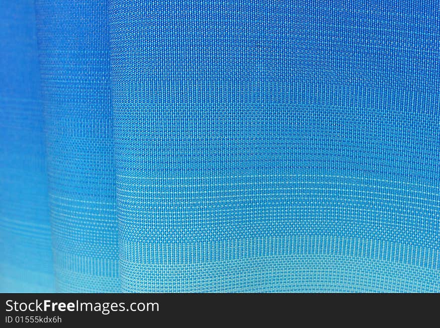 Wavy fabric texture with a gradient from blue to light blue. Wavy fabric texture with a gradient from blue to light blue