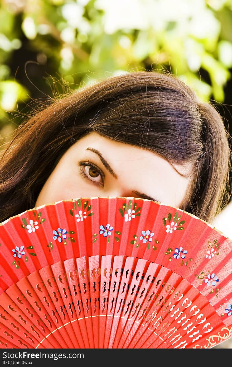 Spanish woman behind traditional fan. Spanish woman behind traditional fan.